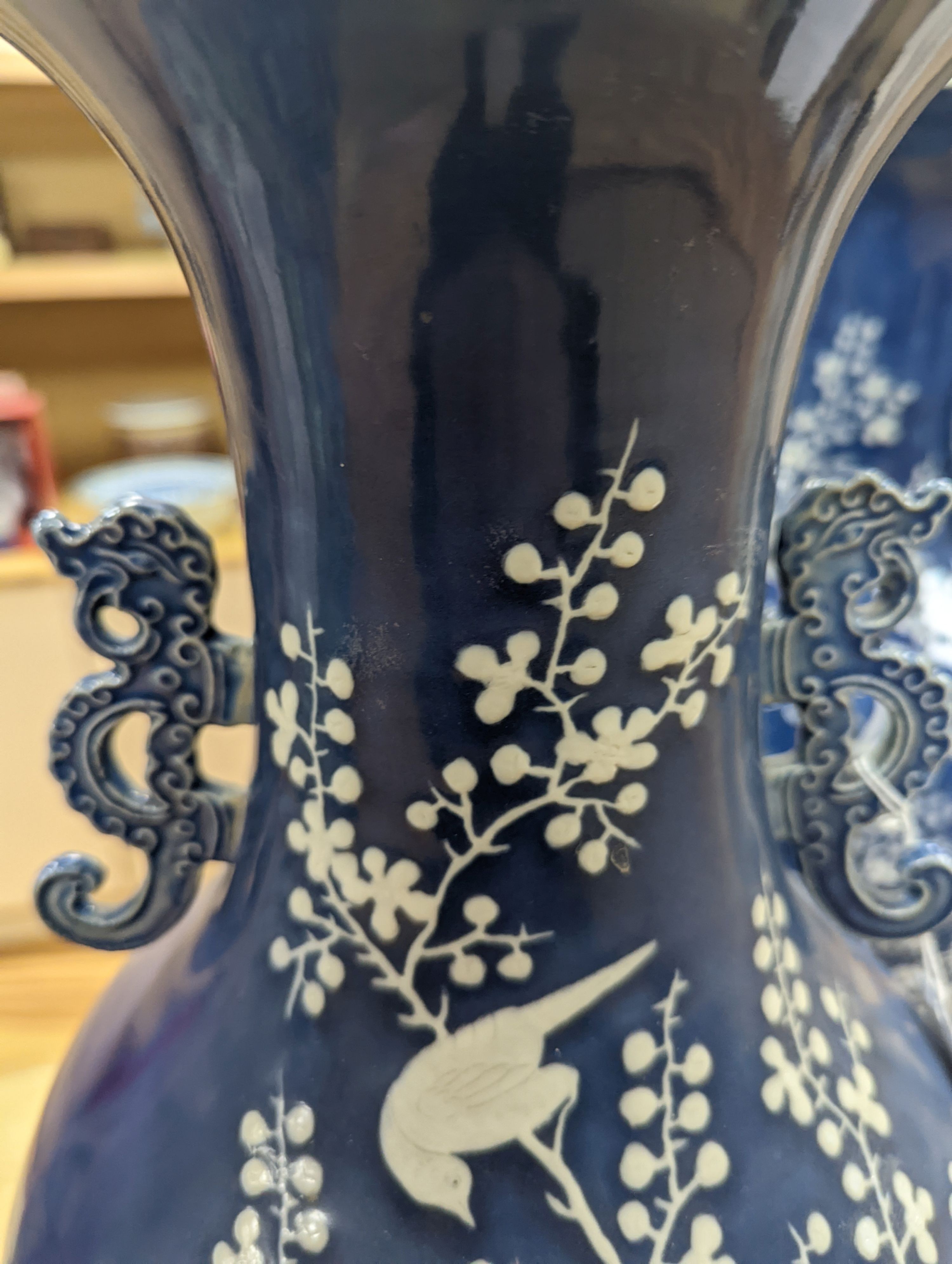 A pair of large 19th century Chinese slip decorated blue ground vases, restored, 59cm